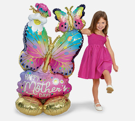 Child with heart balloons